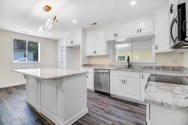 406 Mercer St, Goldsboro, NC 27530 - kitchen with dishwasher, a sink, white cabinets, dark wood-style floors, and recessed lighting