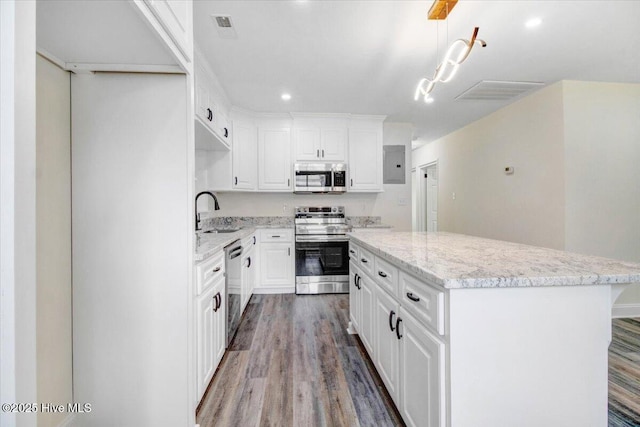 406 Mercer St, Goldsboro, NC 27530 - kitchen featuring appliances with stainless steel finishes, a sink, a center island, and wood finished floors
