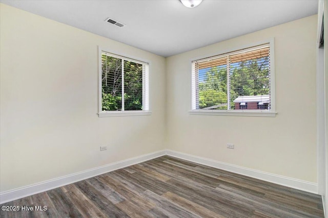 406 Mercer St, Goldsboro, NC 27530 - spare room featuring healthy amount of natural light, dark wood-style flooring, and baseboards