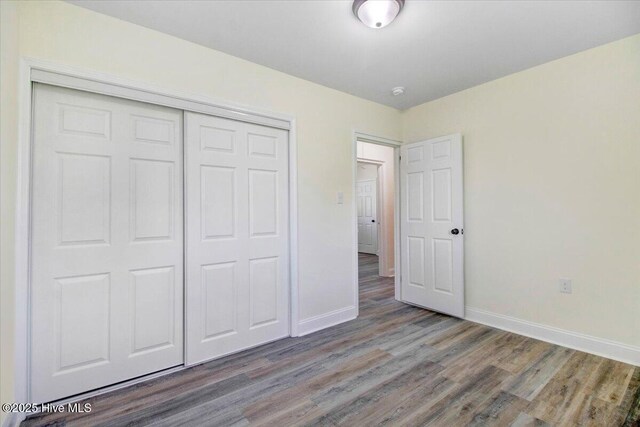 406 Mercer St, Goldsboro, NC 27530 - unfurnished bedroom with wood finished floors, baseboards, and a closet
