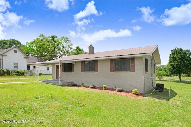 406 Mercer St, Goldsboro, NC 27530 - view of front of house with brick siding, a chimney, metal roof, and central air condition unit