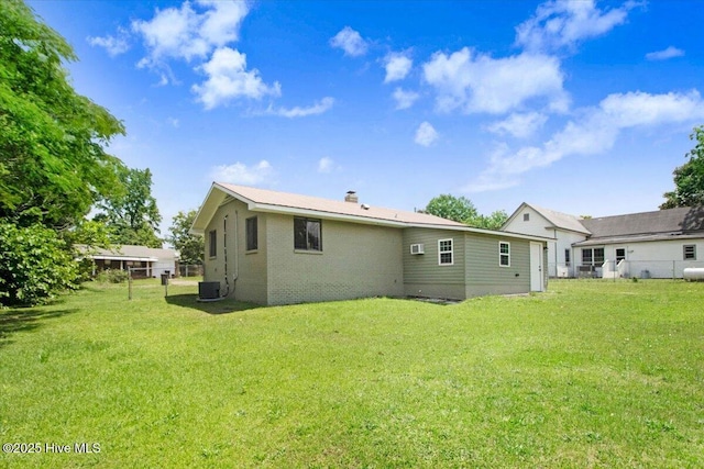 406 Mercer St, Goldsboro, NC 27530 - rear view of property with central air condition unit, brick siding, and a chimney