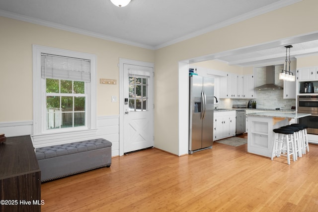 2008 S Elm St, Greenville, NC 27858 - kitchen with stainless steel appliances, wall chimney exhaust hood, a sink, crown molding, and a breakfast bar