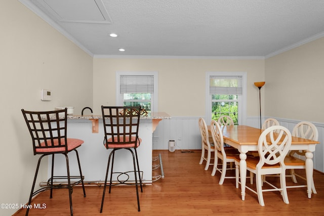 2008 S Elm St, Greenville, NC 27858 - dining space featuring light wood-style floors, a wainscoted wall, ornamental molding, recessed lighting, and a textured ceiling