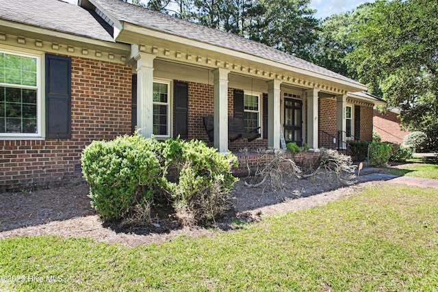 2008 S Elm St, Greenville, NC 27858 - property entrance with brick siding, a porch, a lawn, and a shingled roof