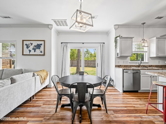 118 Prospect Dr, Richlands, NC 28574 - dining space featuring ornamental molding, a chandelier, and light wood-style flooring