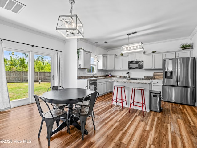 118 Prospect Dr, Richlands, NC 28574 - dining space with wood finished floors, ornamental molding, and a chandelier
