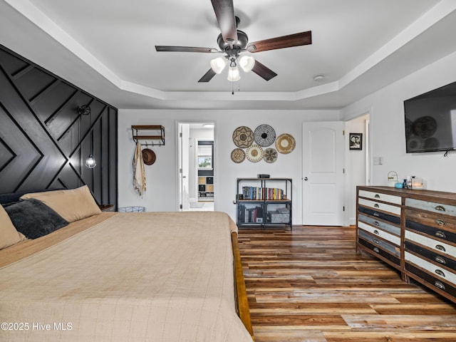 118 Prospect Dr, Richlands, NC 28574 - bedroom featuring wood finished floors, a tray ceiling, and a ceiling fan