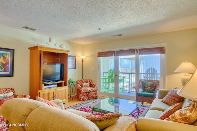 living area with a textured ceiling