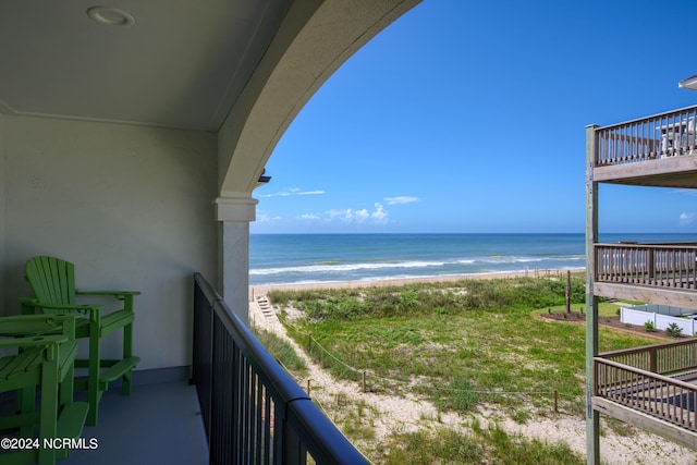 balcony featuring view of water and beach
