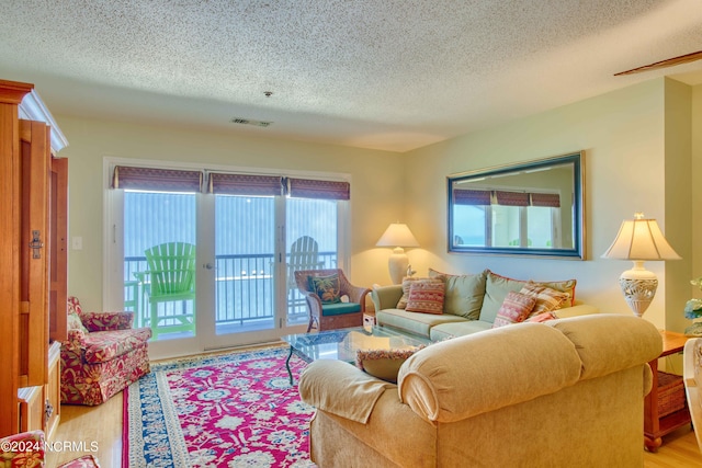 living area with a textured ceiling and wood finished floors