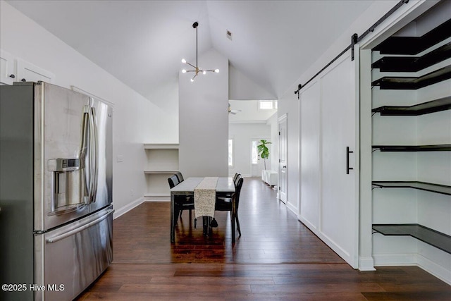 222 Station House Rd, New Bern, NC 28562 - dining space with a barn door, dark wood-style flooring, high vaulted ceiling, a chandelier, and baseboards
