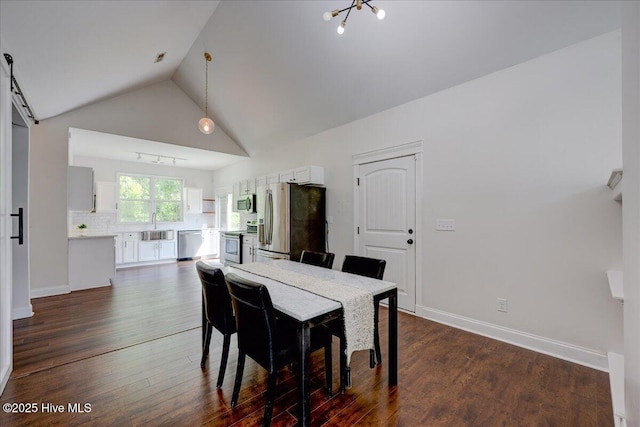 222 Station House Rd, New Bern, NC 28562 - dining space with vaulted ceiling, dark wood-style floors, and baseboards