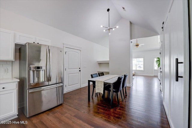 222 Station House Rd, New Bern, NC 28562 - dining room with dark wood-style flooring, a chandelier, high vaulted ceiling, and baseboards