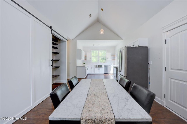 222 Station House Rd, New Bern, NC 28562 - dining area featuring vaulted ceiling, dark wood finished floors, and a barn door