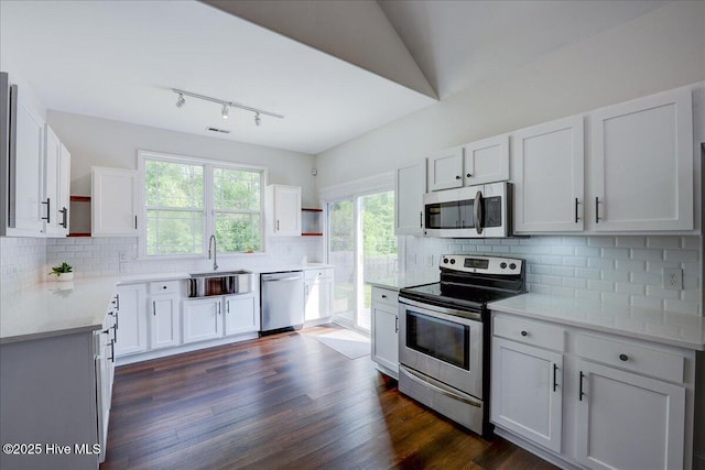 222 Station House Rd, New Bern, NC 28562 - kitchen with appliances with stainless steel finishes, a sink, tasteful backsplash, light countertops, and white cabinetry
