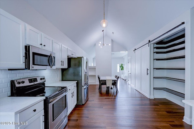 222 Station House Rd, New Bern, NC 28562 - kitchen featuring appliances with stainless steel finishes, vaulted ceiling, white cabinetry, a barn door, and dark wood-style floors