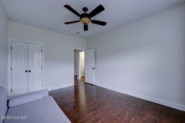 222 Station House Rd, New Bern, NC 28562 - unfurnished bedroom with dark wood-style flooring, baseboards, a closet, and ceiling fan