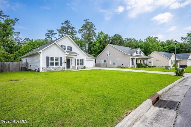 222 Station House Rd, New Bern, NC 28562 - rear view of property with board and batten siding, driveway, cooling unit, and stone siding