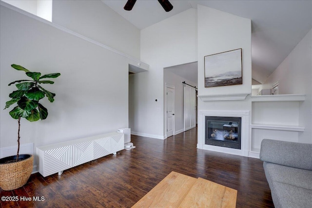 222 Station House Rd, New Bern, NC 28562 - living area with high vaulted ceiling, a ceiling fan, wood finished floors, baseboards, and a glass covered fireplace