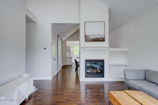 222 Station House Rd, New Bern, NC 28562 - living area featuring wood finished floors, lofted ceiling, baseboards, built in shelves, and a glass covered fireplace