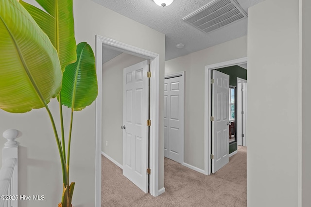 hall with carpet flooring and baseboards