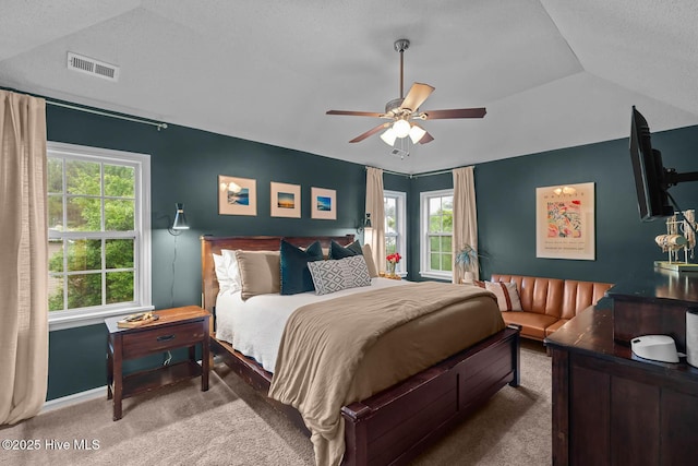 bedroom featuring carpet flooring, multiple windows, a ceiling fan, lofted ceiling, and baseboards
