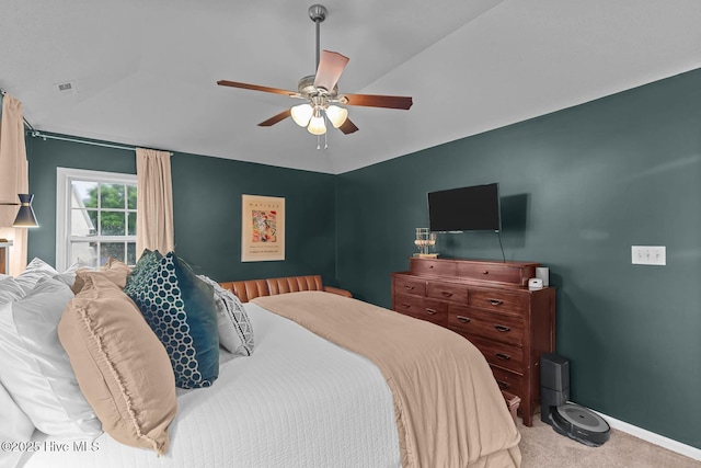 carpeted bedroom with a ceiling fan and baseboards