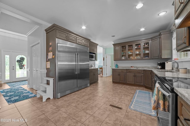 859 Old Pamlico Beach Rd W, Belhaven, NC 27810 - kitchen featuring built in appliances, crown molding, a sink, healthy amount of natural light, and glass insert cabinets