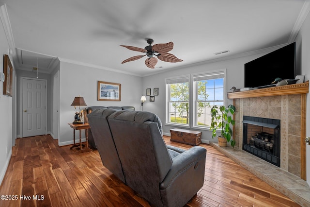 859 Old Pamlico Beach Rd W, Belhaven, NC 27810 - living room with attic access, ceiling fan, hardwood / wood-style flooring, a tiled fireplace, and ornamental molding