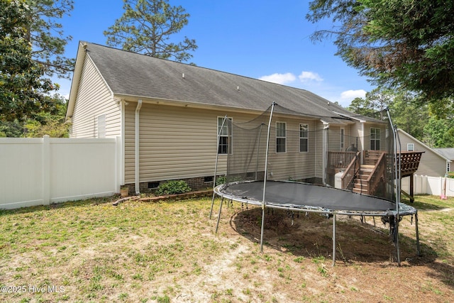 144 Newington Way, Aberdeen, NC 28315 - rear view of house with a trampoline, crawl space, roof with shingles, a wooden deck, and stairway