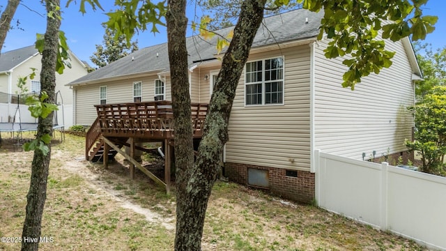 144 Newington Way, Aberdeen, NC 28315 - back of house with a trampoline, a deck, crawl space, a shingled roof, and stairway