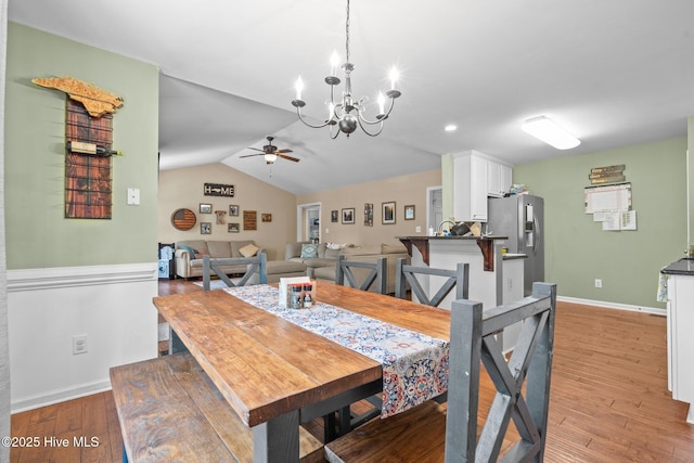 144 Newington Way, Aberdeen, NC 28315 - dining room with a chandelier, ceiling fan, light wood-style floors, baseboards, and vaulted ceiling
