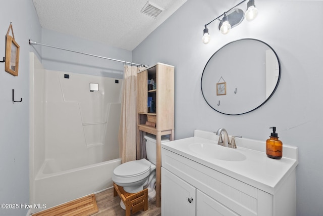 303 Foxtrace Ln, Hubert, NC 28539 - bathroom with vanity, a textured ceiling, toilet, wood finished floors, and shower / bath combo with shower curtain
