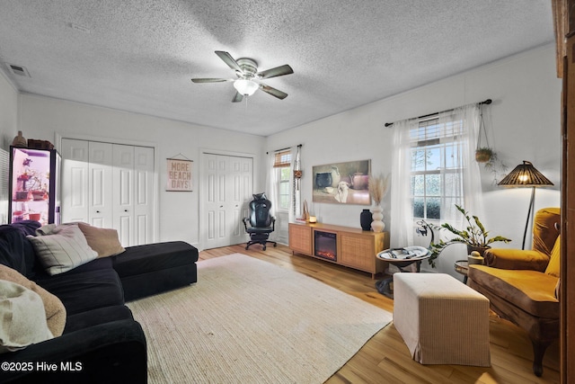 303 Foxtrace Ln, Hubert, NC 28539 - living area featuring wood finished floors, a ceiling fan, and a textured ceiling