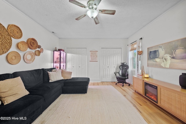303 Foxtrace Ln, Hubert, NC 28539 - living area featuring light wood finished floors, a textured ceiling, and a ceiling fan