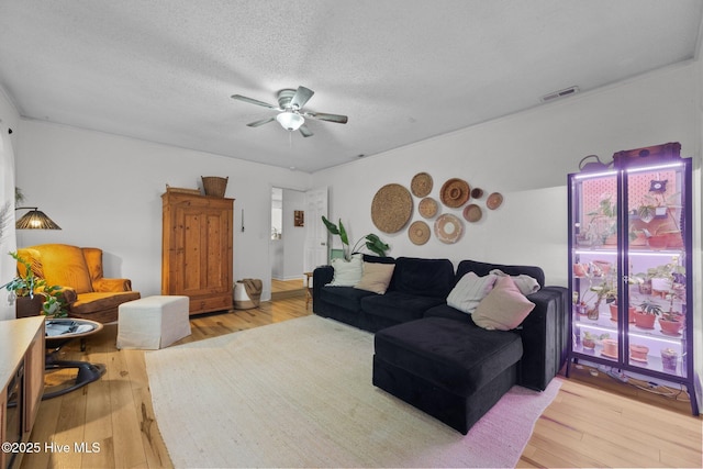 303 Foxtrace Ln, Hubert, NC 28539 - living area with ceiling fan, light wood finished floors, and a textured ceiling