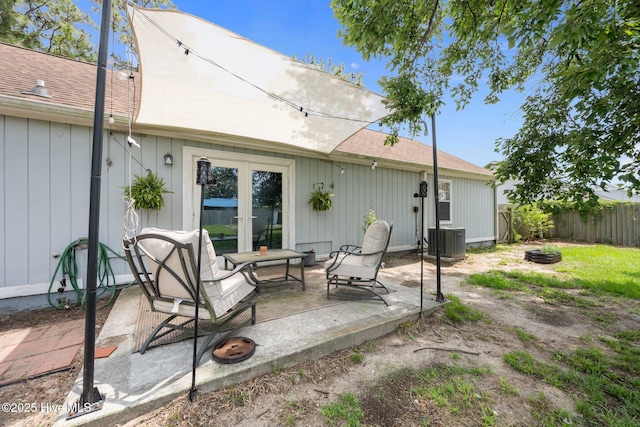 303 Foxtrace Ln, Hubert, NC 28539 - back of house featuring fence, central AC, a shingled roof, and an outdoor fire pit
