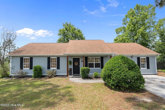 303 Foxtrace Ln, Hubert, NC 28539 - view of front of home with a front yard and roof with shingles