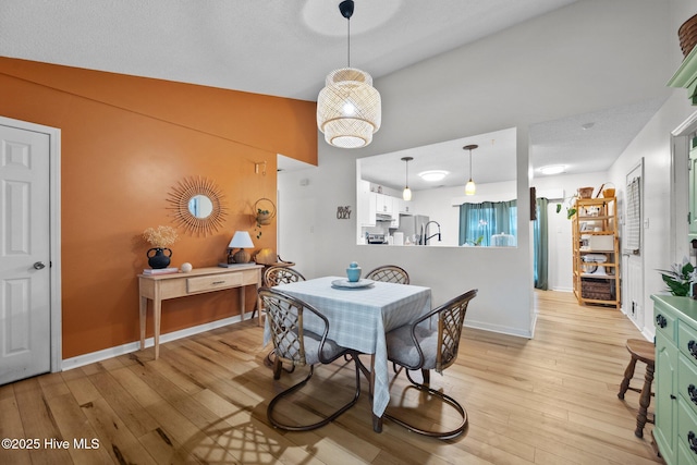 303 Foxtrace Ln, Hubert, NC 28539 - dining space with light wood-style floors, baseboards, and high vaulted ceiling