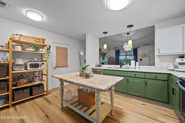 303 Foxtrace Ln, Hubert, NC 28539 - kitchen featuring green cabinets, a sink, light countertops, light wood-style floors, and a textured ceiling