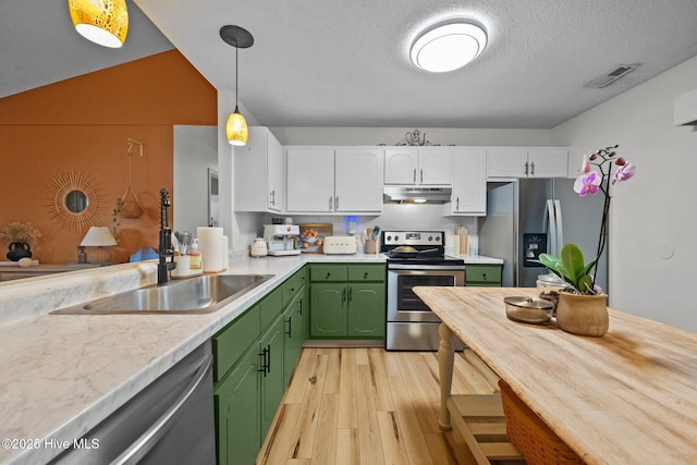 303 Foxtrace Ln, Hubert, NC 28539 - kitchen with stainless steel appliances, under cabinet range hood, green cabinets, a sink, and white cabinets