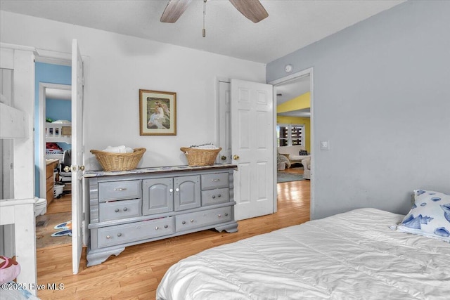 4407 E Oak Island Dr, Oak Island, NC 28465 - bedroom featuring light wood-type flooring and a ceiling fan