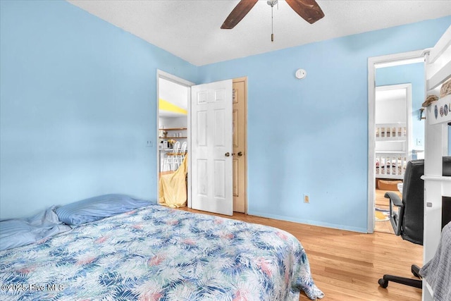4407 E Oak Island Dr, Oak Island, NC 28465 - bedroom featuring wood finished floors, baseboards, a ceiling fan, connected bathroom, and an office area