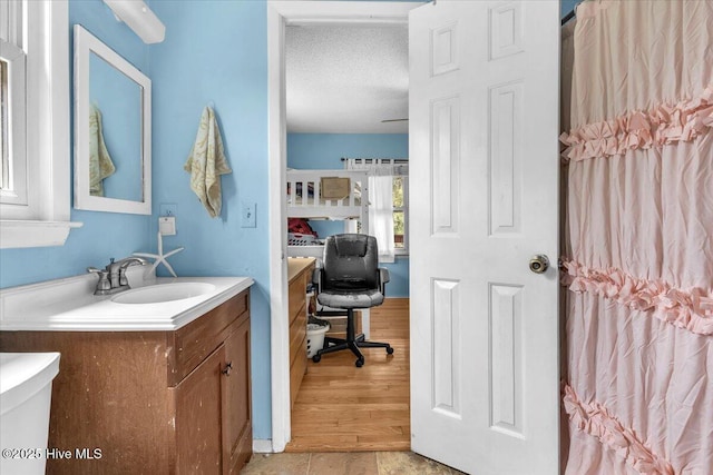 4407 E Oak Island Dr, Oak Island, NC 28465 - bathroom featuring vanity and a textured ceiling