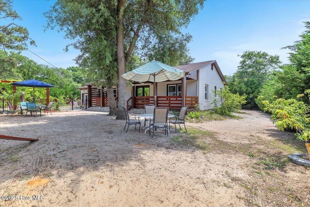 4407 E Oak Island Dr, Oak Island, NC 28465 - rear view of house with outdoor dining area