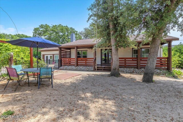 4407 E Oak Island Dr, Oak Island, NC 28465 - back of property featuring french doors and a patio area
