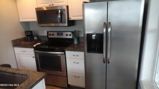 105 Sandy Landing Rd, Cedar Island, NC 28520 - kitchen with stainless steel appliances, white cabinets, and dark stone counters