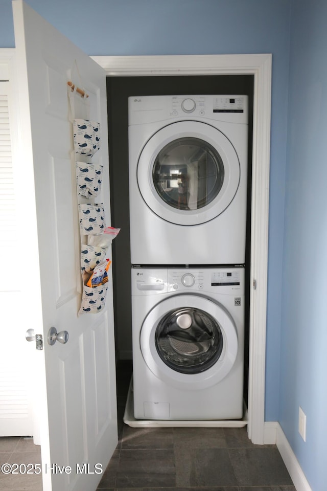 105 Sandy Landing Rd, Cedar Island, NC 28520 - laundry room with stacked washing machine and dryer, baseboards, and tile patterned flooring