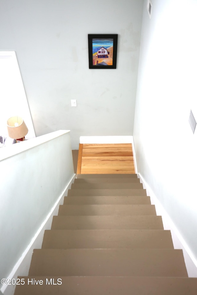 105 Sandy Landing Rd, Cedar Island, NC 28520 - stairway with wood finished floors and baseboards